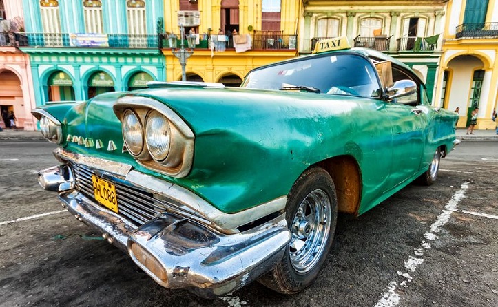 Vintage car in a colorful neighborhood in hHvana